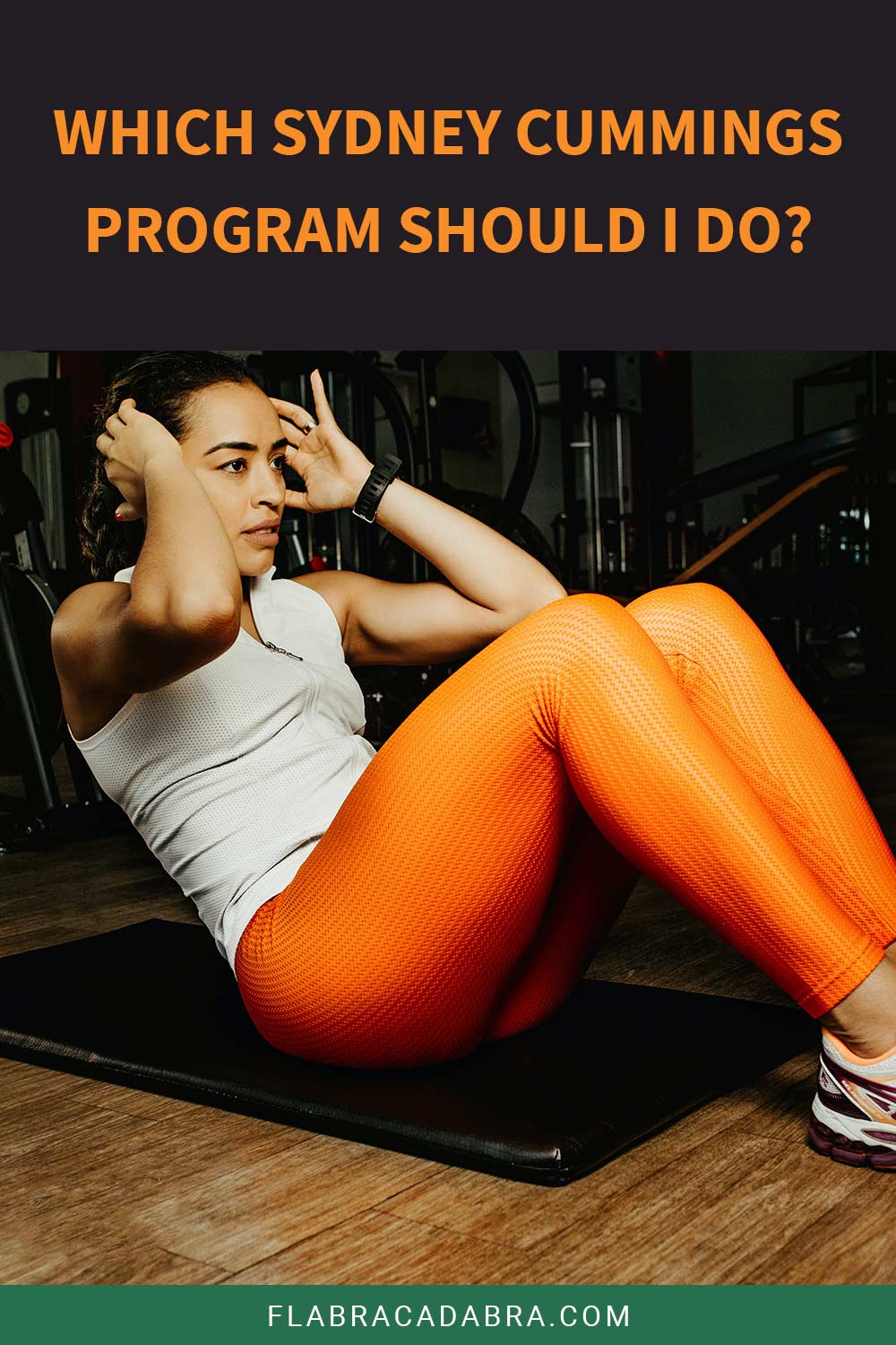 Woman in orange leggings and white shirt doing sit ups - Which Sydney Cummings Program Should I Do?
