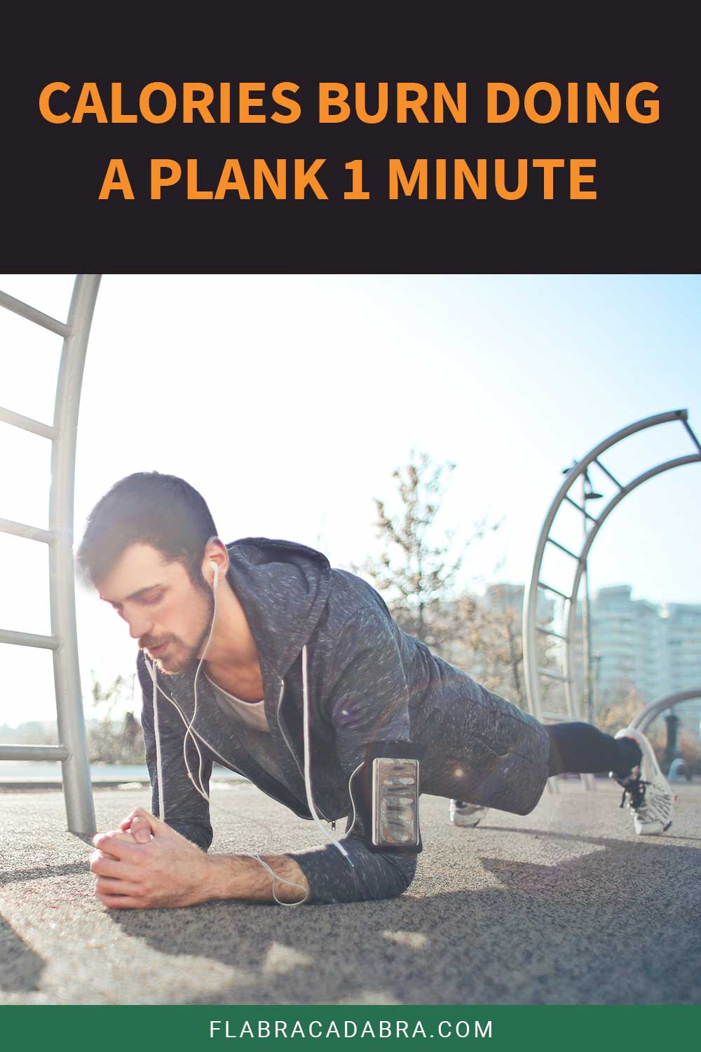 Man in grey hoodie and shorts doing a plank on concrete outside - Calories burn doing a it in 1 minute.