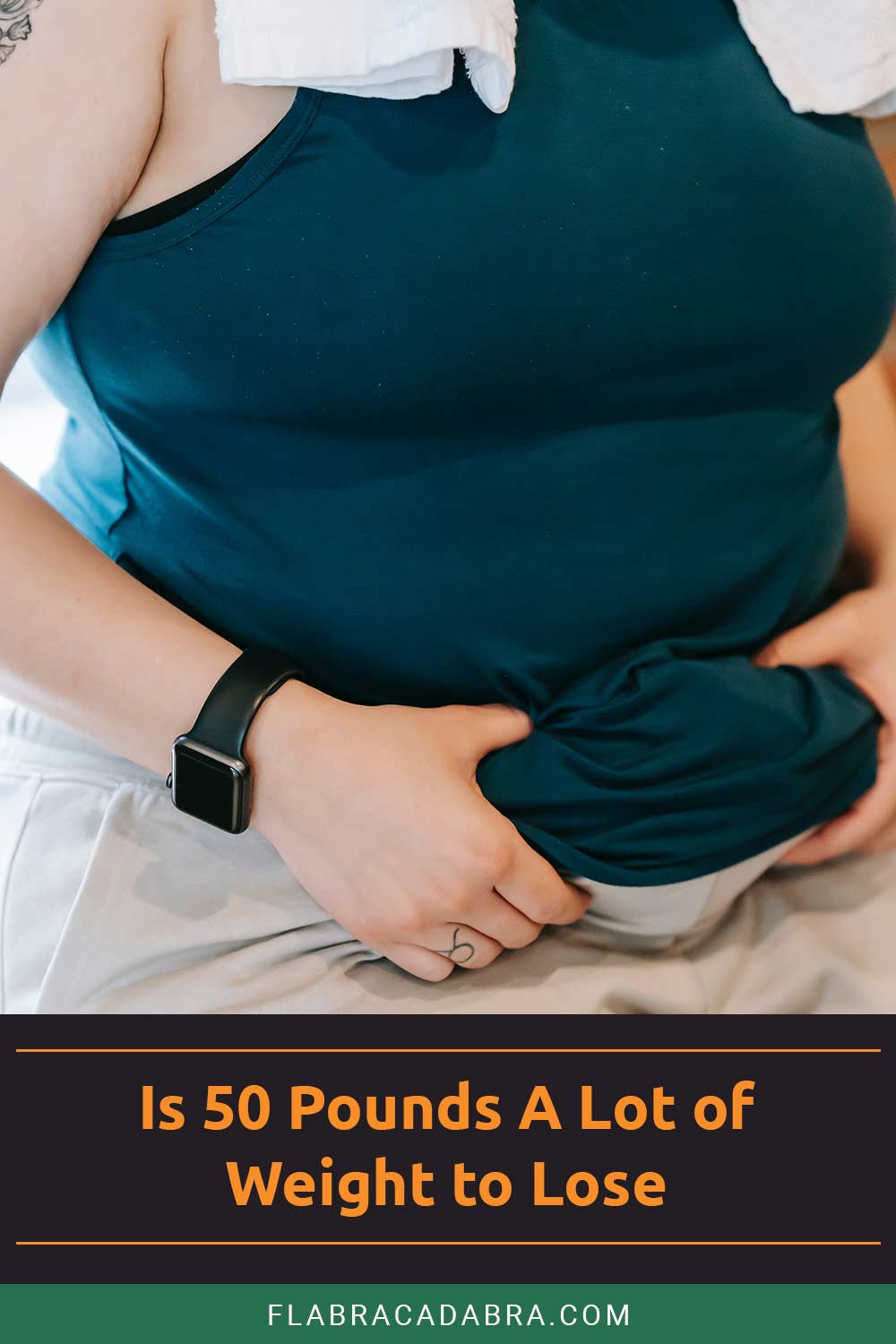 Person grabbing belly fat with two hands - Is 50 Pounds A Lot of Weight to Lose?